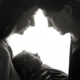 mum dad and newborn baby girl backlit